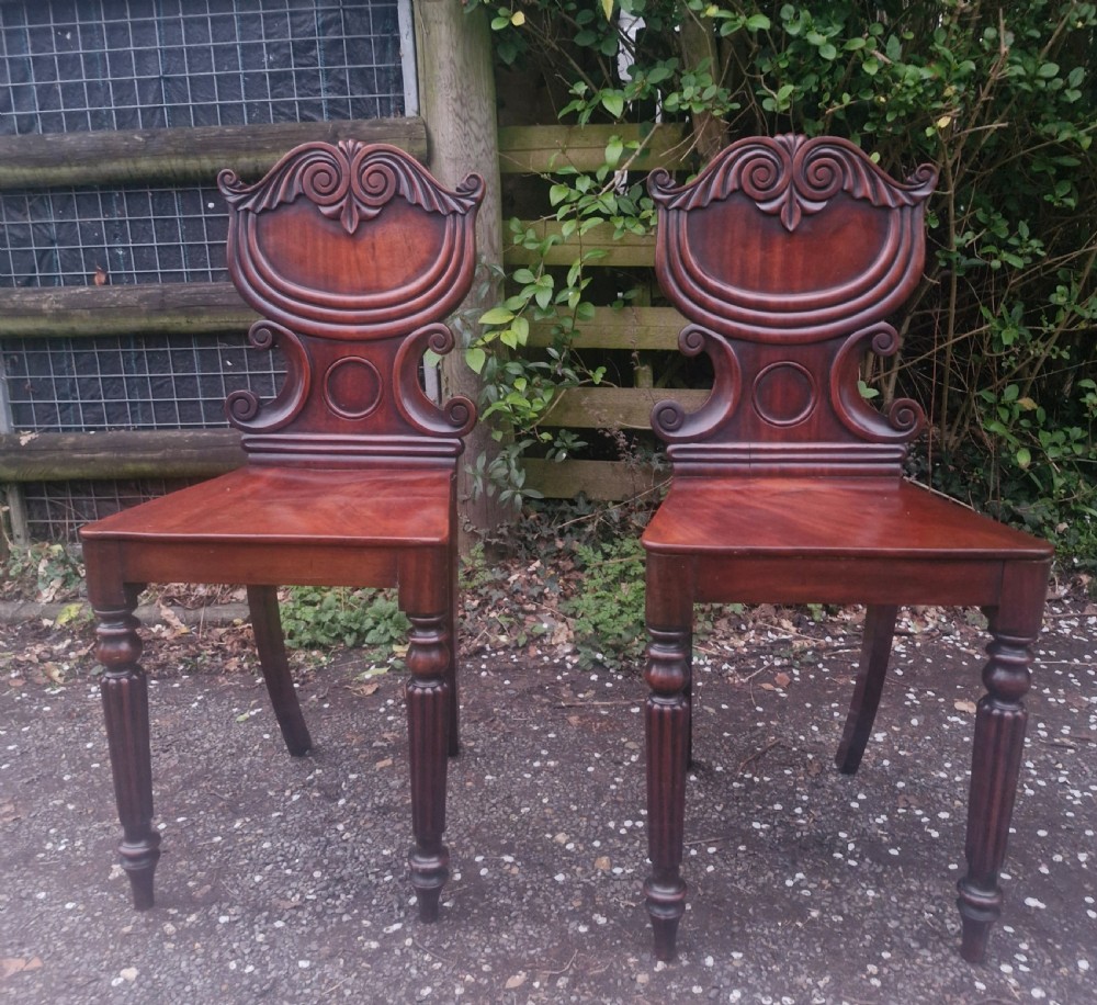 Pair of Regency mahogany hall chairs. 