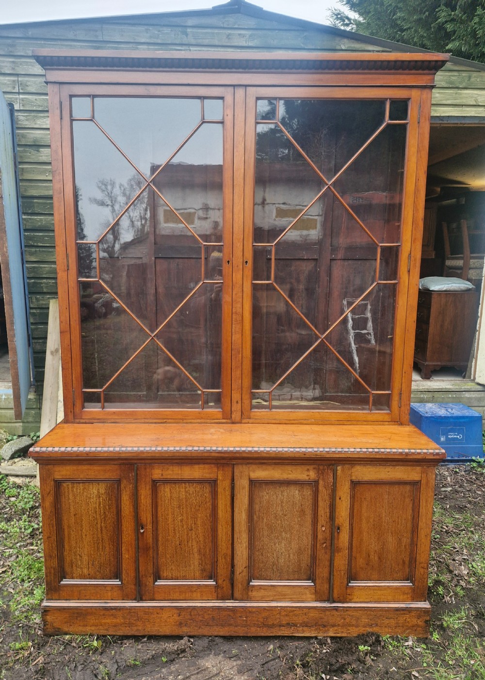 A two-part Victorian glazed wooden bookcase cabinet featuring upper astragal glass doors and four lower solid timber panelled cupboard doors. View XI