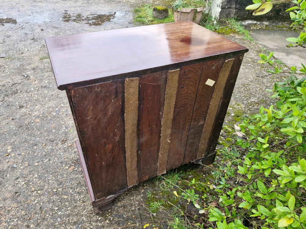 An 18th-century Georgian mahogany chest of drawers featuring four graduated drawers with brass swan-neck handles, a pull-out brushing slide, and bracket feet. View II