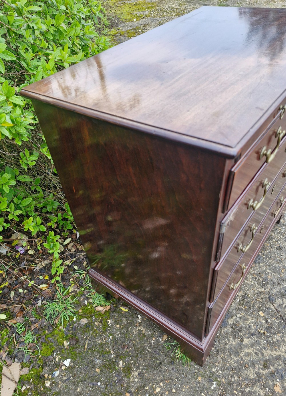 An 18th-century Georgian mahogany chest of drawers featuring four graduated drawers with brass swan-neck handles, a pull-out brushing slide, and bracket feet. View VII