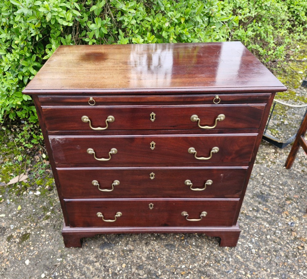 An 18th-century Georgian mahogany chest of drawers featuring four graduated drawers with brass swan-neck handles, a pull-out brushing slide, and bracket feet. View VIII