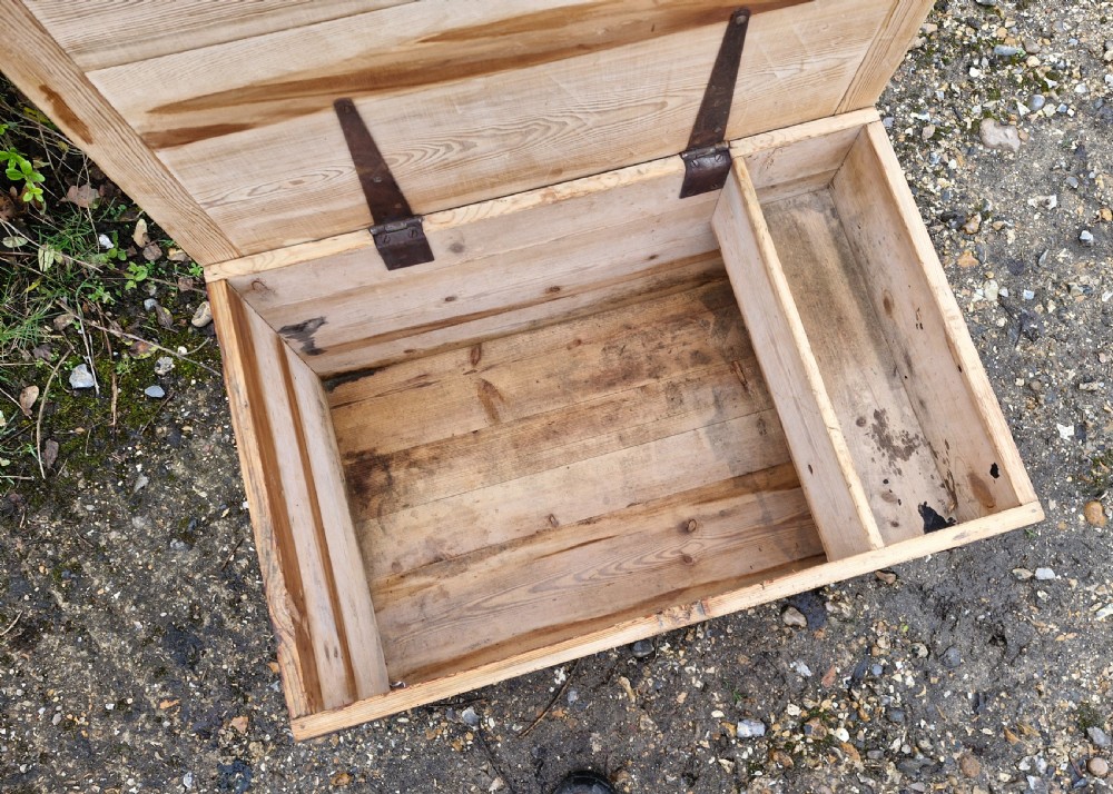 A late Victorian natural pine travelling trunk featuring iron corner brackets, dovetail joinery, and a GPO stencil mark on the front panel. View II