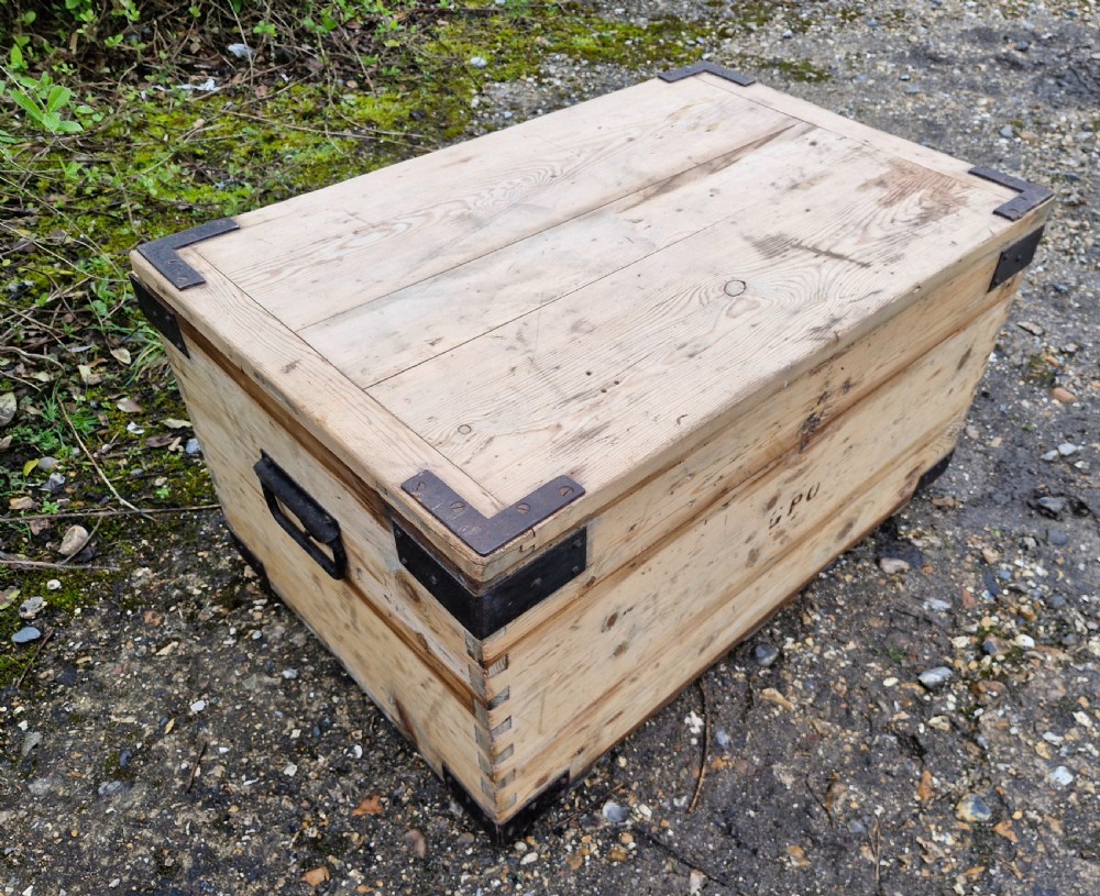 A late Victorian natural pine travelling trunk featuring iron corner brackets, dovetail joinery, and a GPO stencil mark on the front panel. View VI