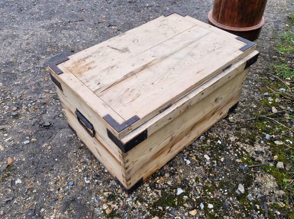 A late Victorian natural pine travelling trunk featuring iron corner brackets, dovetail joinery, and a GPO stencil mark on the front panel. View VII