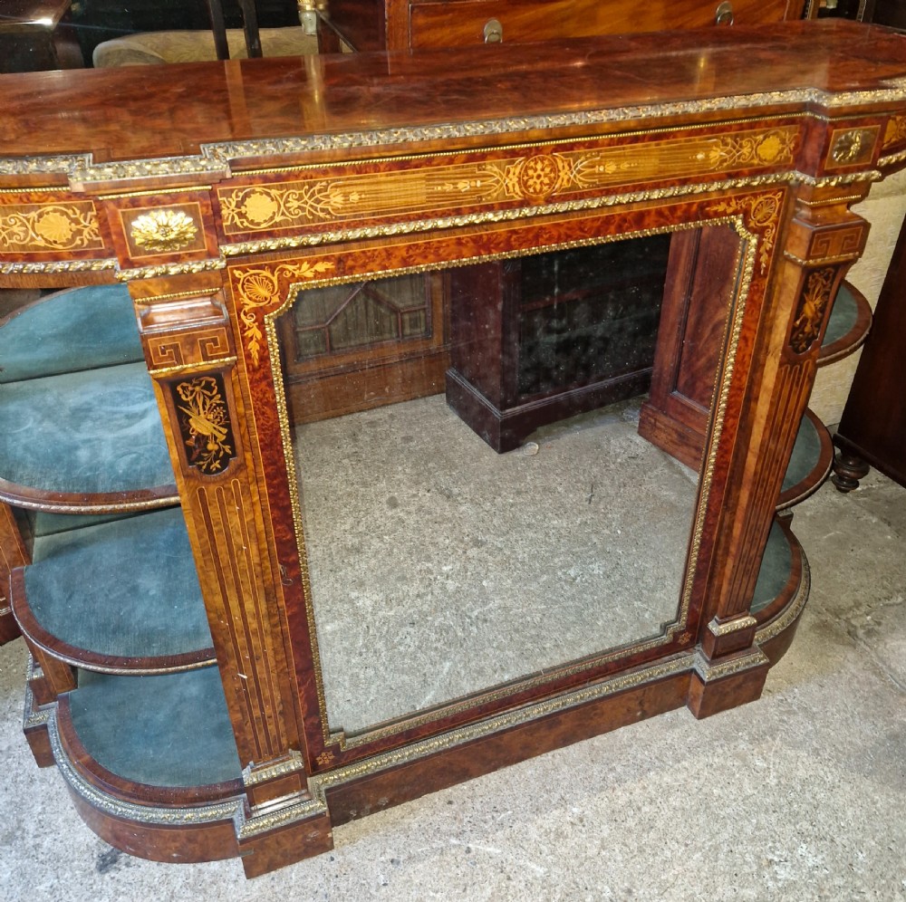 An antique burr walnut side cabinet featuring intricate marquetry inlays, gilt bronze mounts, a central mirror, and open curved side shelves lined in green velvet. View XI