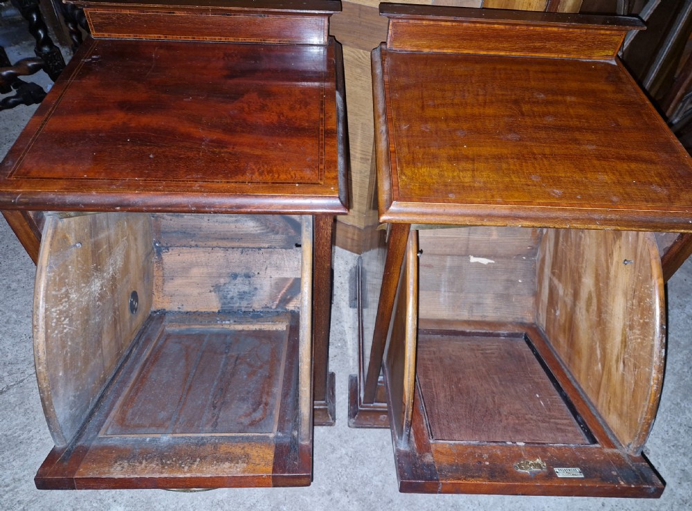 A matched pair of dark mahogany cabinets featuring satinwood stringing, central oval inlaid panels, brass bail handles, and bracket feet. View II