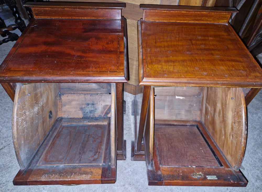 A matched pair of dark mahogany cabinets featuring satinwood stringing, central oval inlaid panels, brass bail handles, and bracket feet. View III