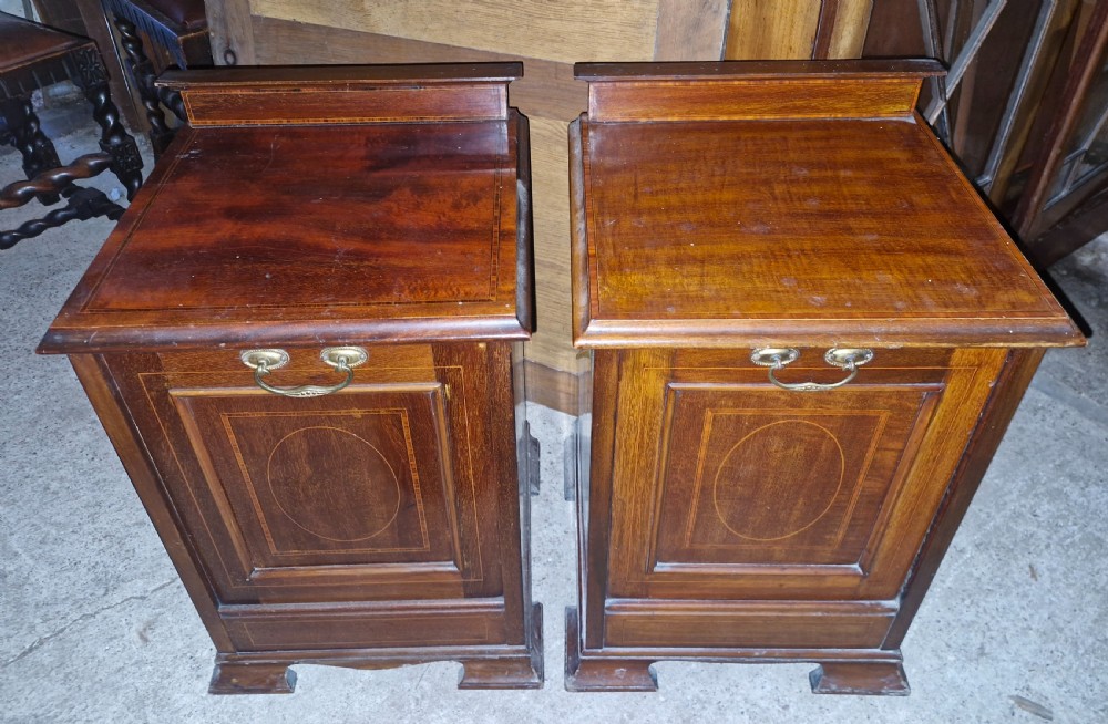 A matched pair of dark mahogany cabinets featuring satinwood stringing, central oval inlaid panels, brass bail handles, and bracket feet. View IV