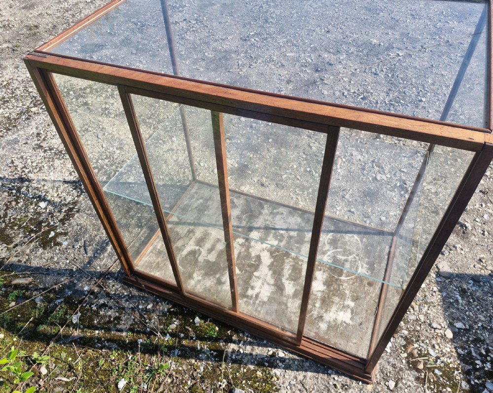 A rectangular glazed tabletop shop display cabinet featuring a dark mahogany timber frame, glass side panels, a glass top, and a single internal glass shelf. View II