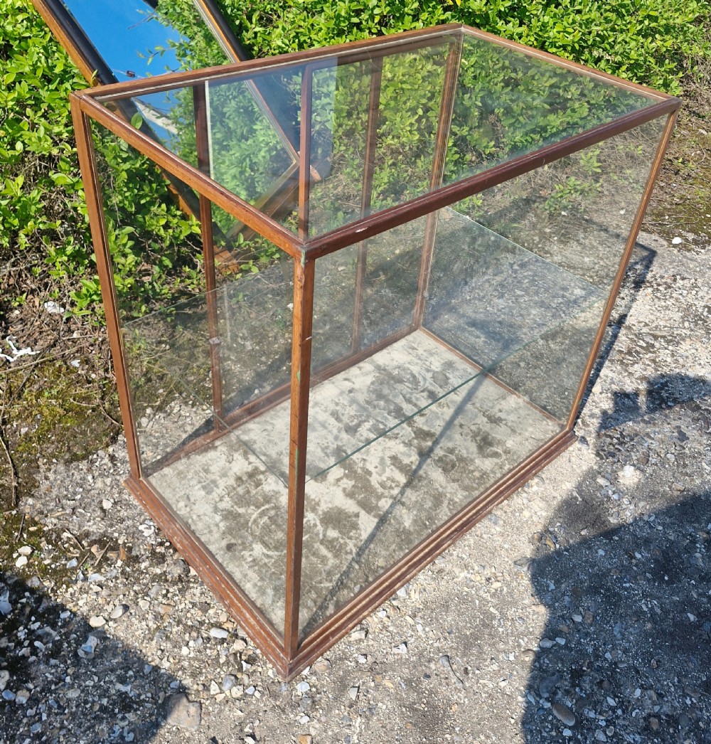 A rectangular glazed tabletop shop display cabinet featuring a dark mahogany timber frame, glass side panels, a glass top, and a single internal glass shelf. View III