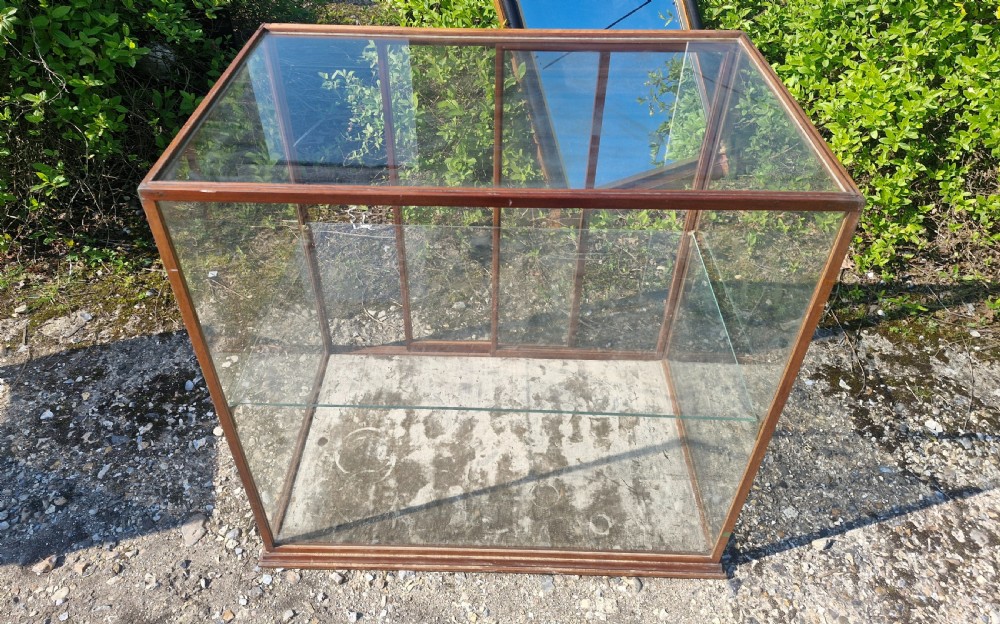 A rectangular glazed tabletop shop display cabinet featuring a dark mahogany timber frame, glass side panels, a glass top, and a single internal glass shelf. View IV