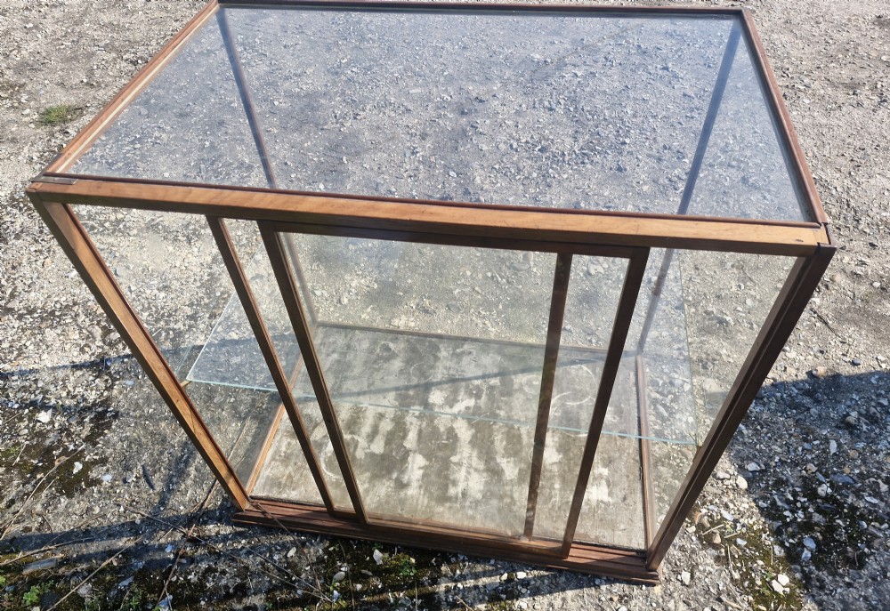 A rectangular glazed tabletop shop display cabinet featuring a dark mahogany timber frame, glass side panels, a glass top, and a single internal glass shelf. View VI