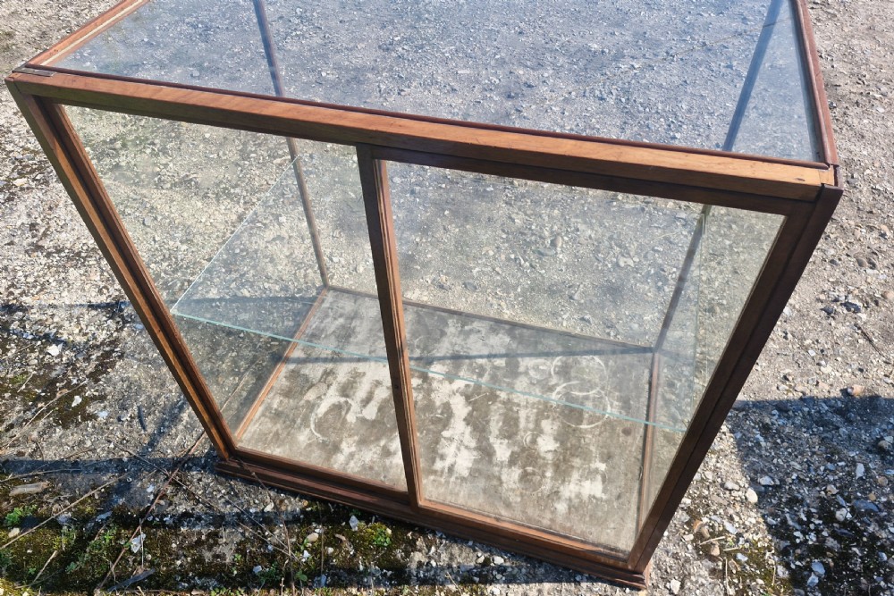 A rectangular glazed tabletop shop display cabinet featuring a dark mahogany timber frame, glass side panels, a glass top, and a single internal glass shelf. View VII