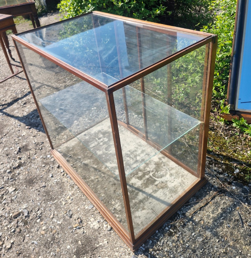 A rectangular glazed tabletop shop display cabinet featuring a dark mahogany timber frame, glass side panels, a glass top, and a single internal glass shelf. View VIII