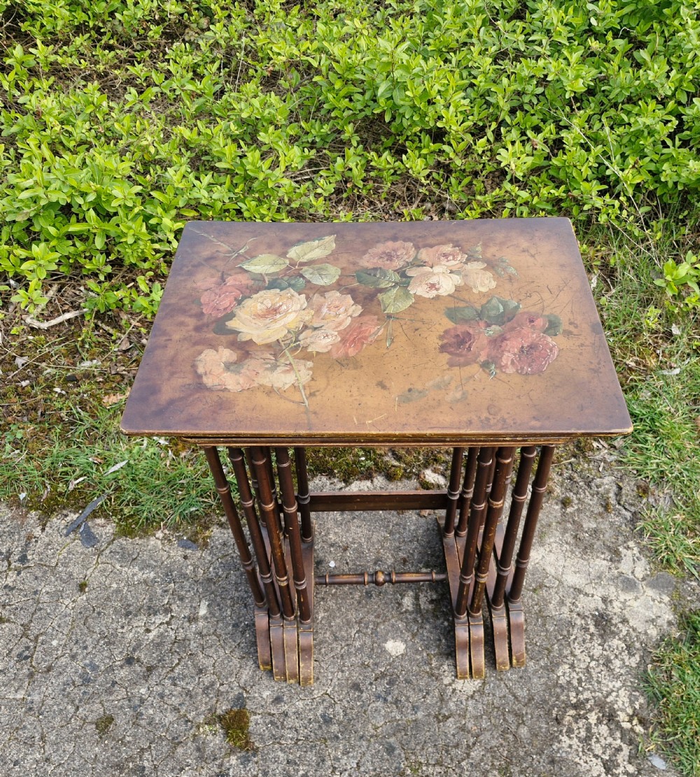 Nest of 4 painted and decorated occasional tables. 