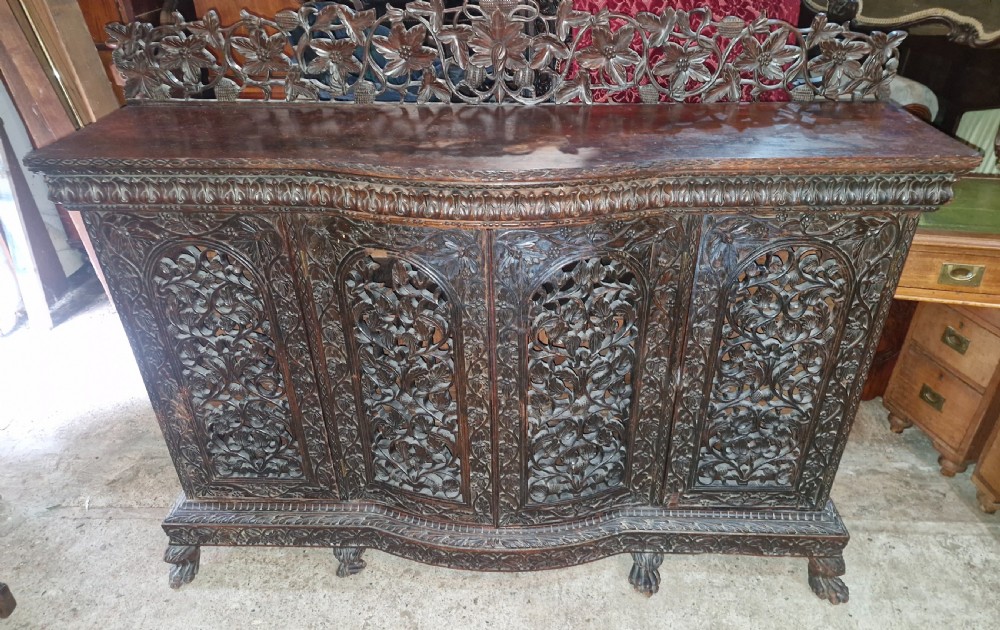 Carved Anglo Indian 4 door side cabinet. 
