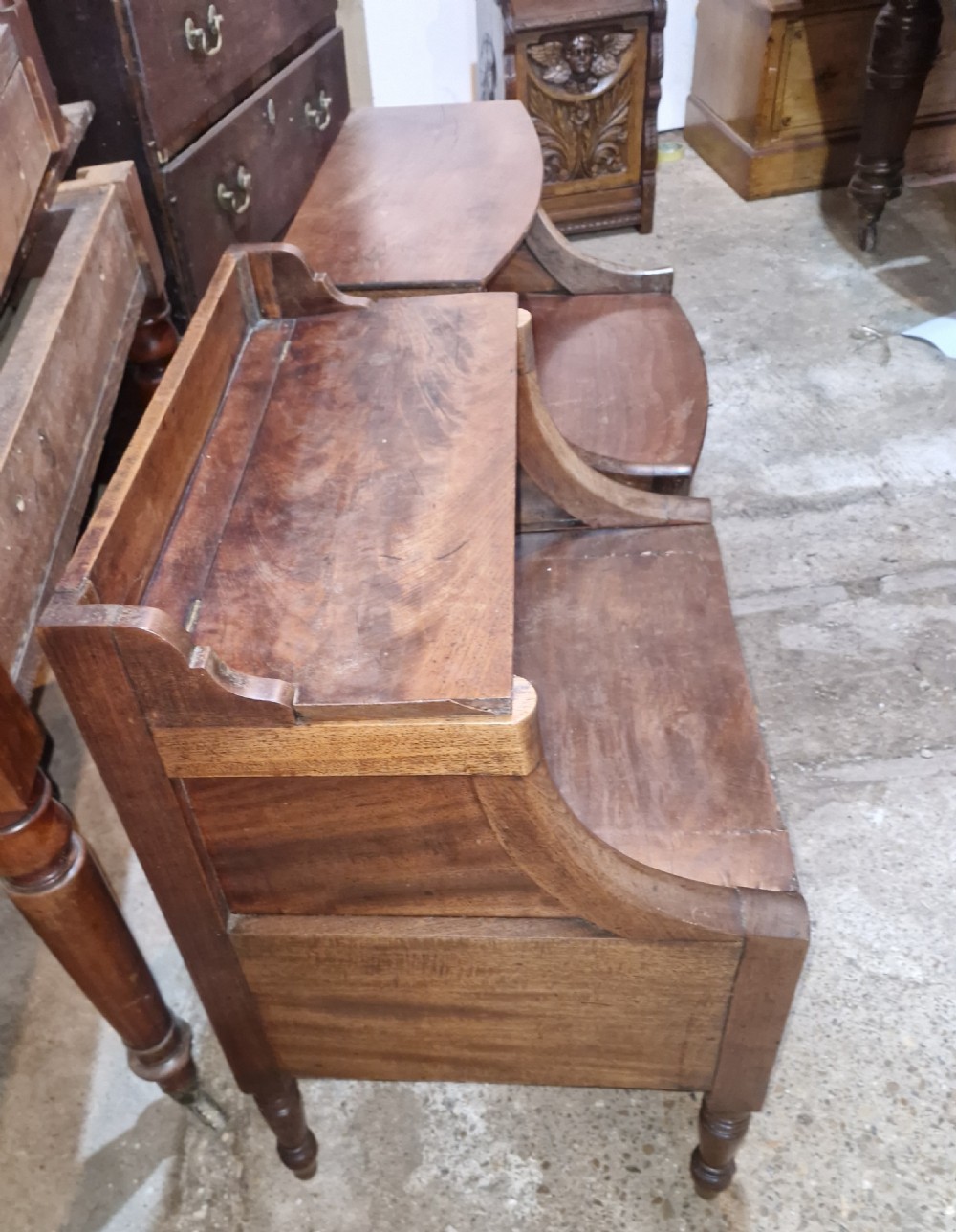 A pair of late Georgian mahogany two-tiered bedside tables with turned front legs and curved side supports. View IV