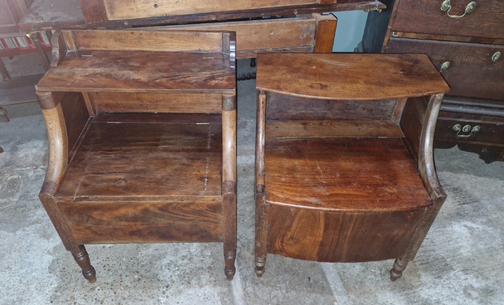 A pair of late Georgian mahogany two-tiered bedside tables with turned front legs and curved side supports. View VII