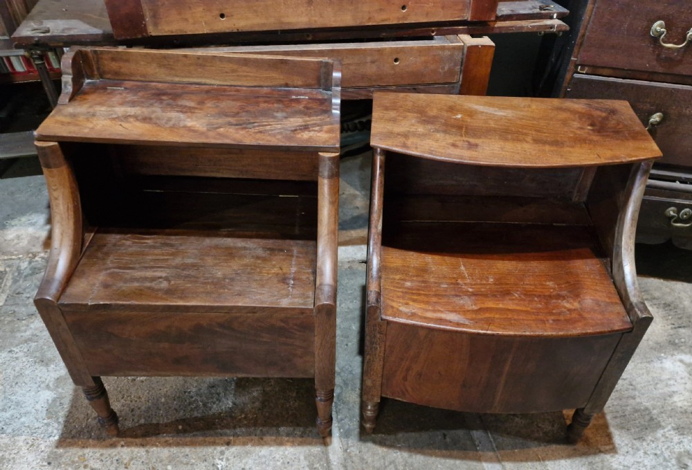 A pair of late Georgian mahogany two-tiered bedside tables with turned front legs and curved side supports. View VIII