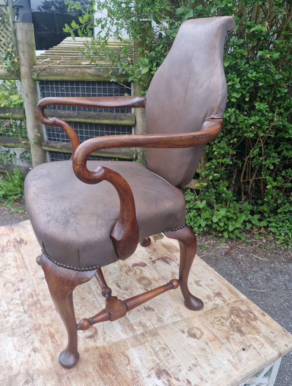 A Queen Anne style desk armchair featuring dark brown leather upholstery, scroll arms, and cabriole legs with turned stretchers. View IV