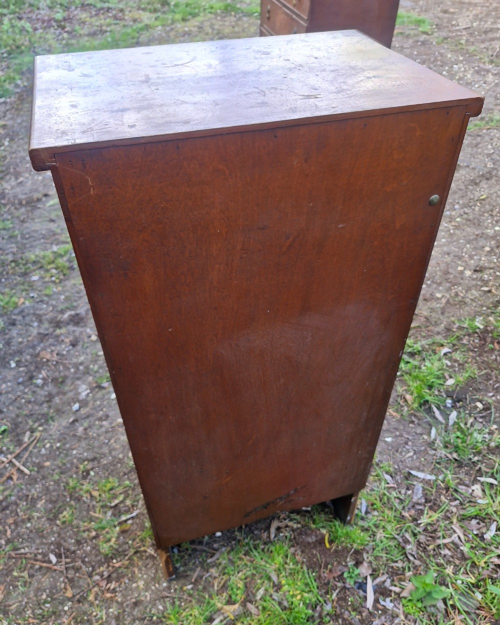 A medium brown vintage wooden five-drawer vertical office cabinet with brass cup handles. View III