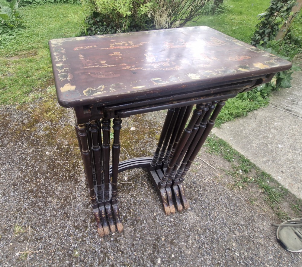 A set of four dark brown lacquered nesting tables decorated with hand-painted gilt chinoiserie landscape scenes and slender turned legs. View XI