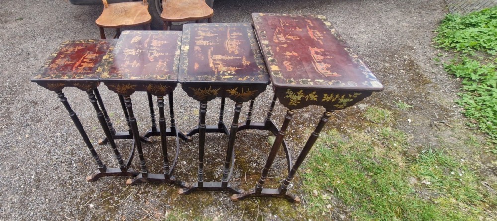 A set of four dark brown lacquered nesting tables decorated with hand-painted gilt chinoiserie landscape scenes and slender turned legs. View XVI