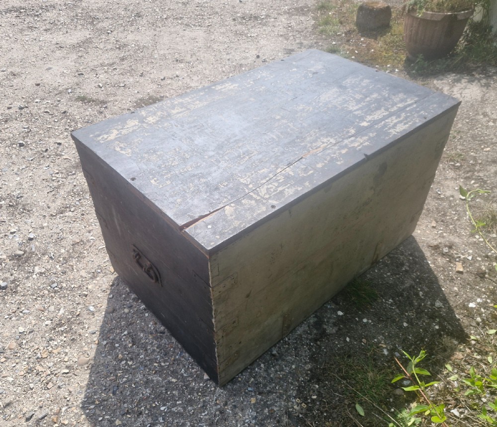 A rectangular antique dark-painted wooden campaign trunk with iron corner brackets and side carrying handles. View III