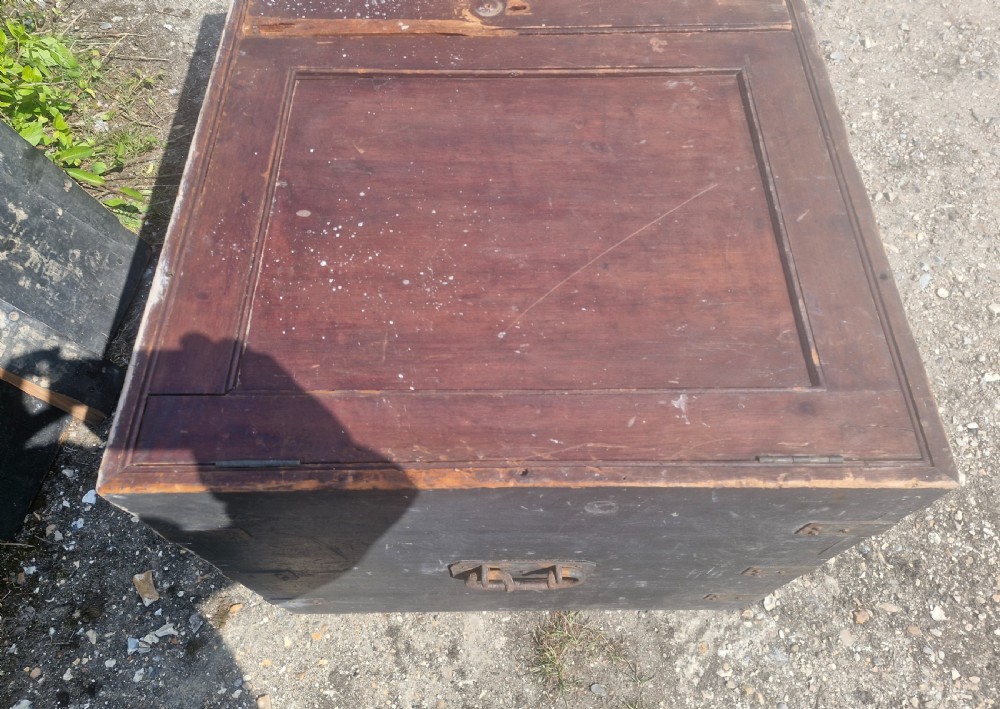A rectangular antique dark-painted wooden campaign trunk with iron corner brackets and side carrying handles. View VI