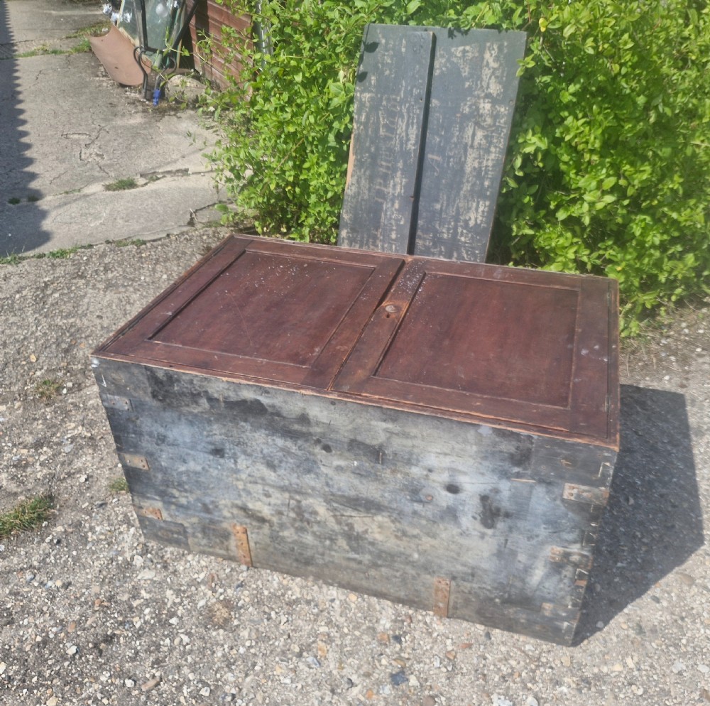 A rectangular antique dark-painted wooden campaign trunk with iron corner brackets and side carrying handles. View VII