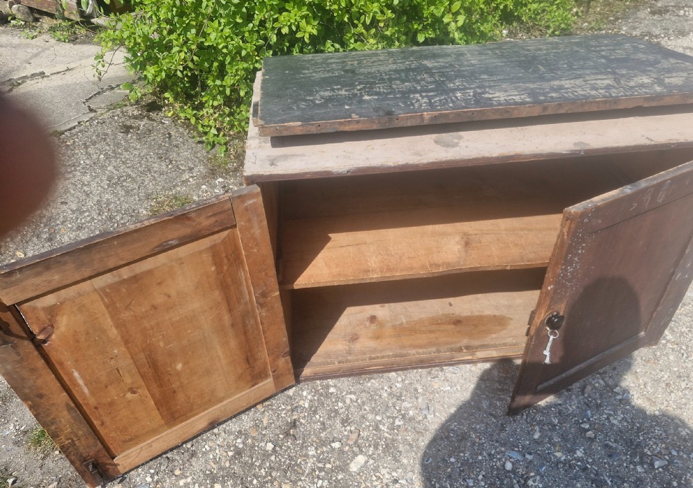 A rectangular antique dark-painted wooden campaign trunk with iron corner brackets and side carrying handles. View VIII