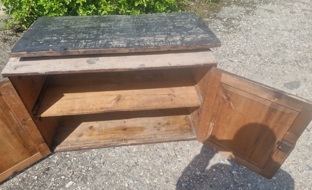 A rectangular antique dark-painted wooden campaign trunk with iron corner brackets and side carrying handles. View IX
