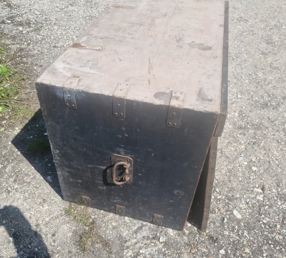 A rectangular antique dark-painted wooden campaign trunk with iron corner brackets and side carrying handles. View XI