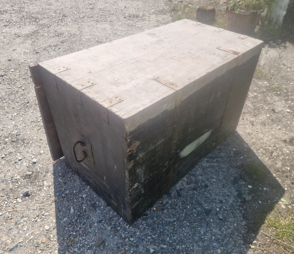 A rectangular antique dark-painted wooden campaign trunk with iron corner brackets and side carrying handles. View XII