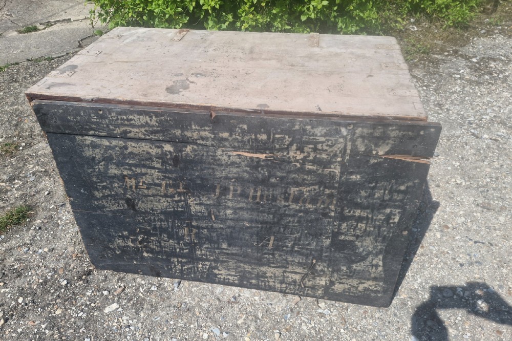A rectangular antique dark-painted wooden campaign trunk with iron corner brackets and side carrying handles. View XIII