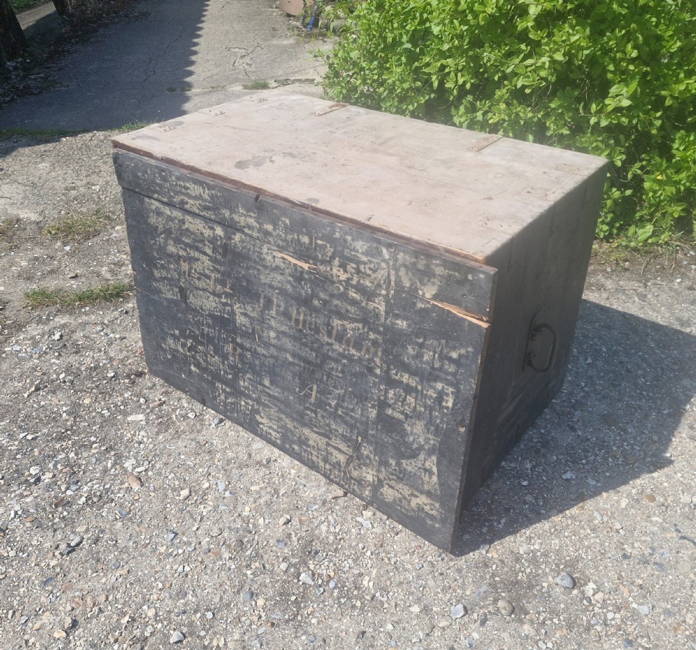 A rectangular antique dark-painted wooden campaign trunk with iron corner brackets and side carrying handles. View XIV