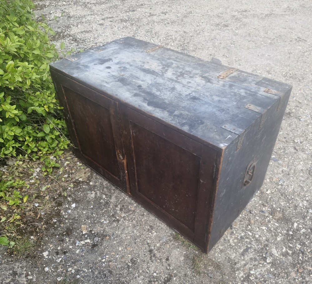 A rectangular antique dark-painted wooden campaign trunk with iron corner brackets and side carrying handles. View XV