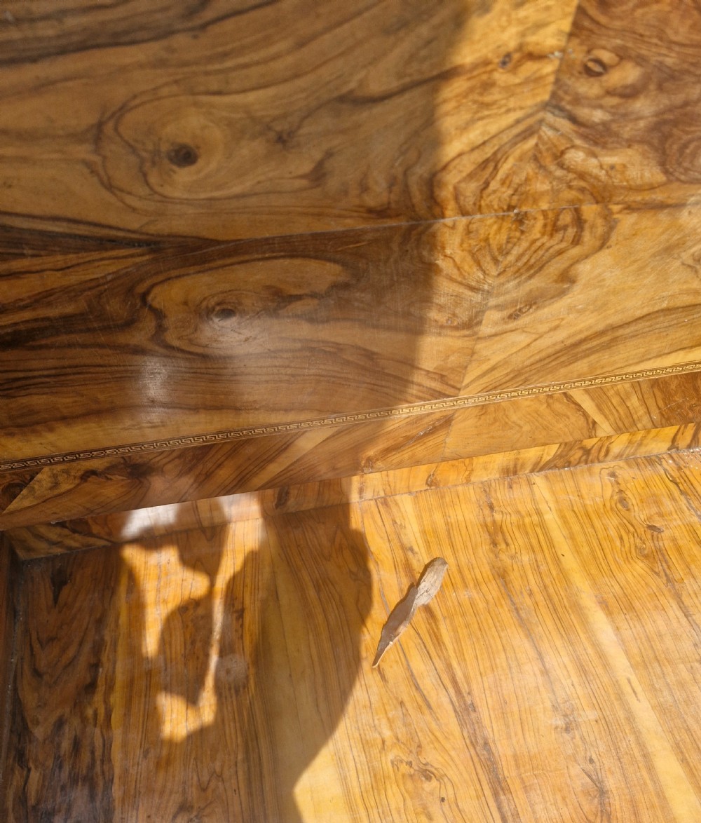 An antique carved olivewood Davenport writing desk with a sloped lid, foliage carvings, and decorative scrolled supports. View XVI