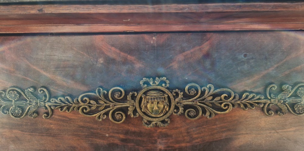 A nineteenth-century French mahogany chest of drawers featuring a dark grey marble top, four drawers with brass drop handles, and flanking side columns. View V