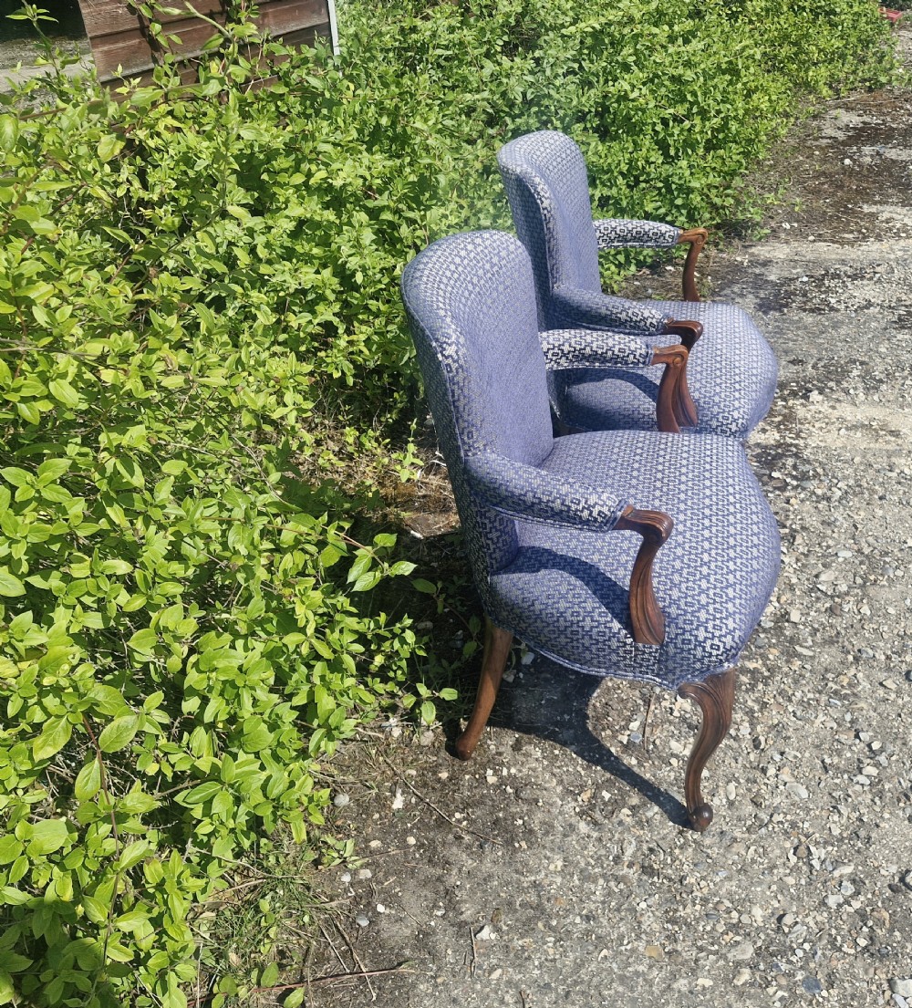 A pair of open arm armchairs with carved mahogany cabriole legs and blue patterned fabric upholstery. View IV