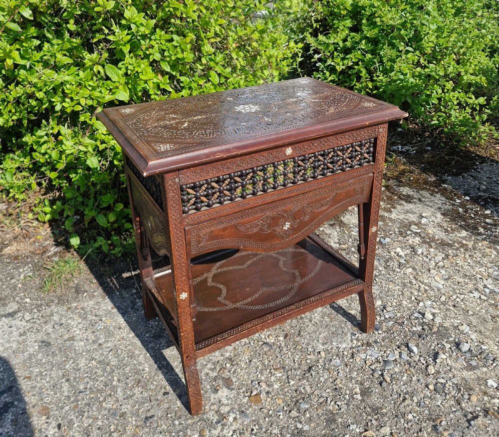 Moorish occasional table with drop sides.