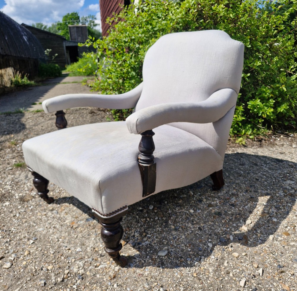 Edwardian low seat upholstered armchair in the Howard style. 