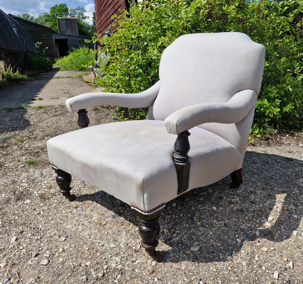 Edwardian low seat upholstered armchair in the Howard style.  View VII