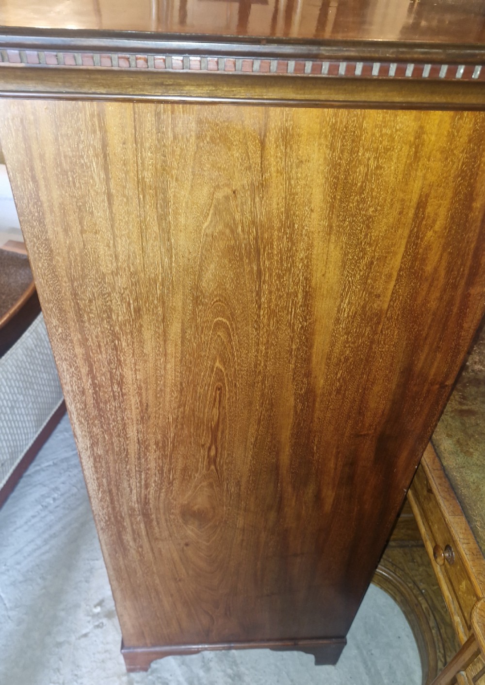 An Edwardian mahogany chest of six drawers featuring satinwood inlay banding, brass drop handles, and bracket feet. View III