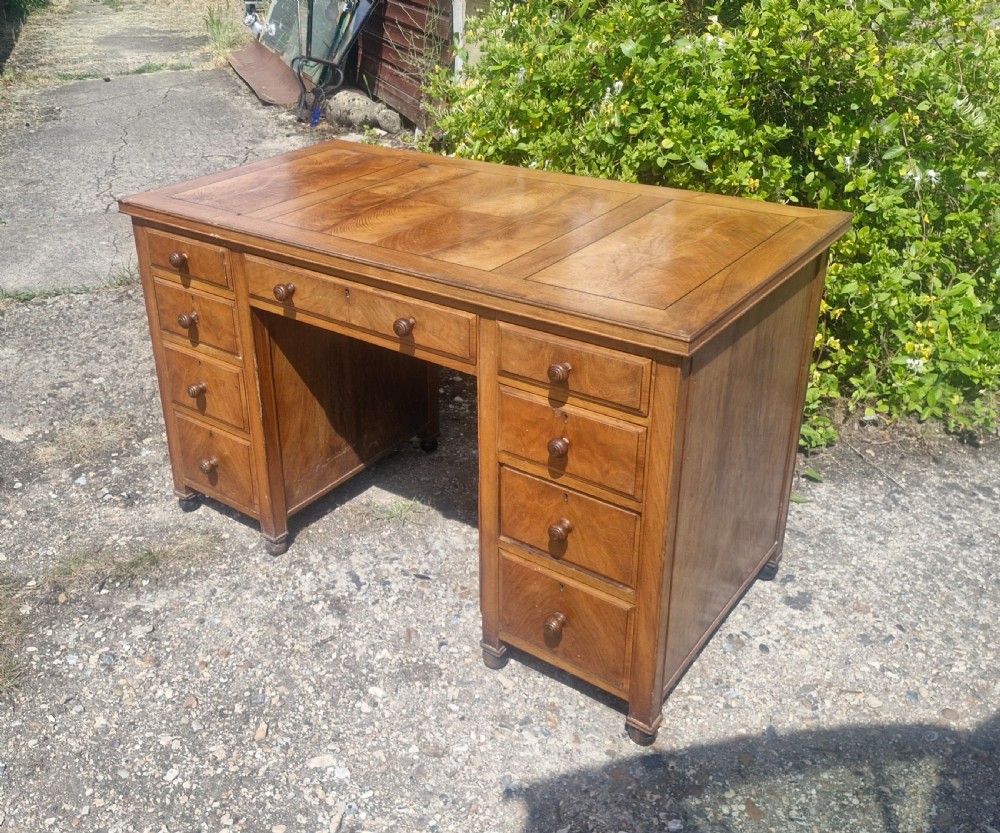 Walnut kneehole pedestal writing desk by Heals.