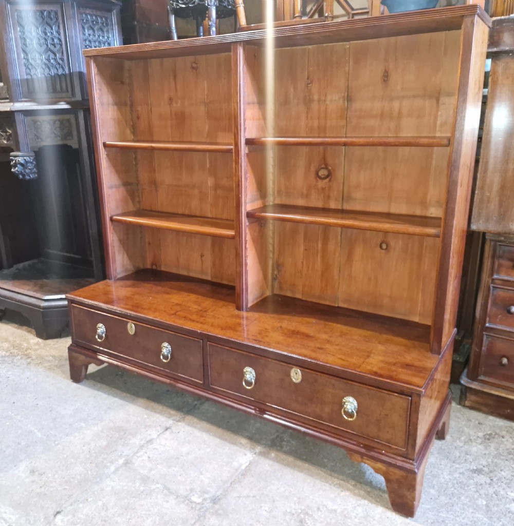 A Regency mahogany dwarf bookcase featuring open adjustable shelves above two lower drawers with brass ring handles. View II
