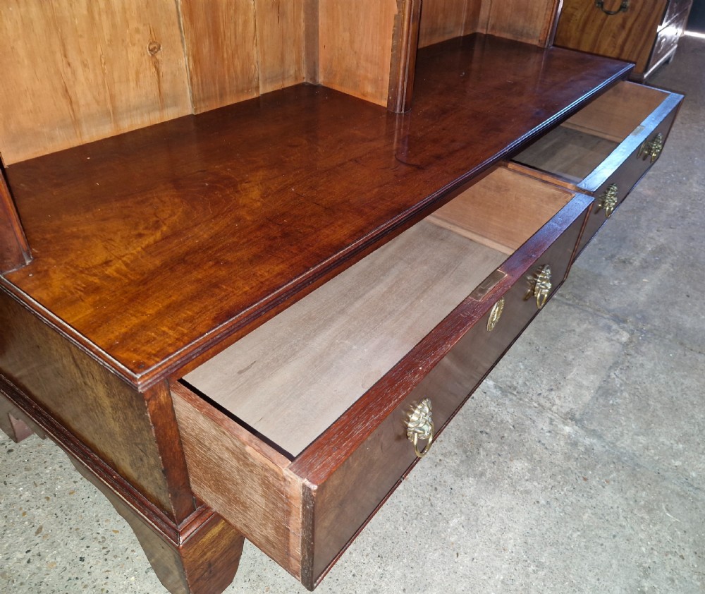 A Regency mahogany dwarf bookcase featuring open adjustable shelves above two lower drawers with brass ring handles. View VII