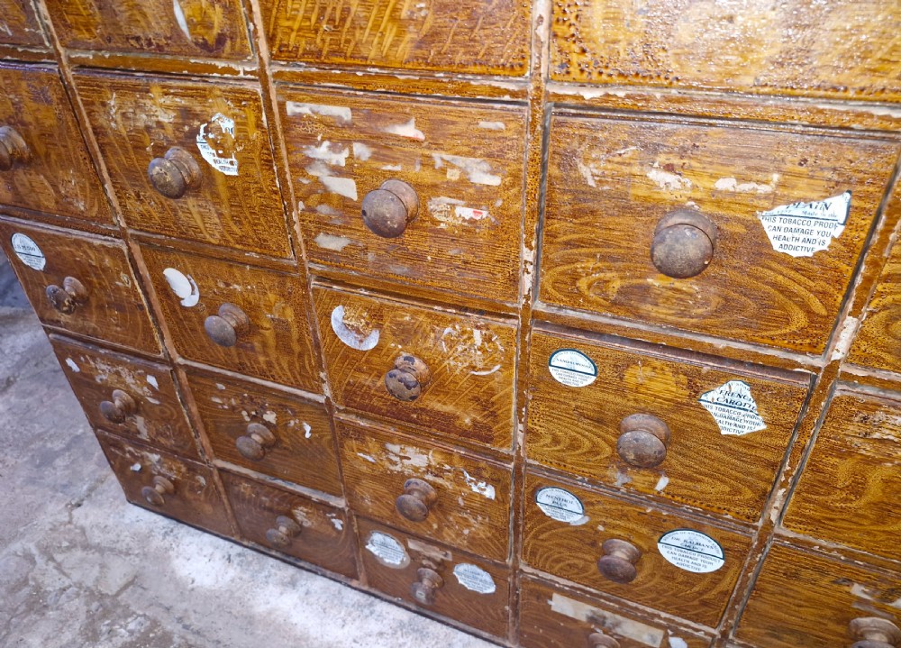 A late Victorian wooden bank of drawers featuring thirty individual drawers arranged in a five by six grid with turned wooden knob handles. View IV
