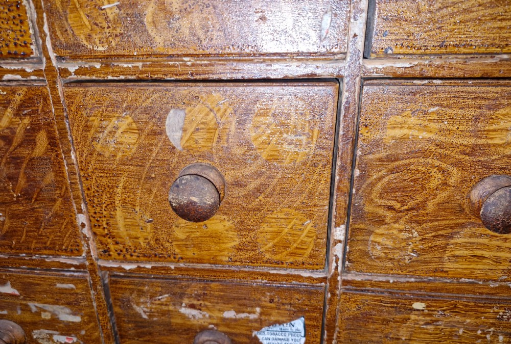 A late Victorian wooden bank of drawers featuring thirty individual drawers arranged in a five by six grid with turned wooden knob handles. View VI