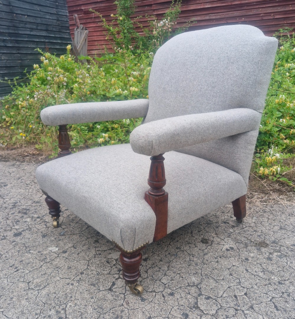 Victorian upholstered armchair with stamp to back leg.